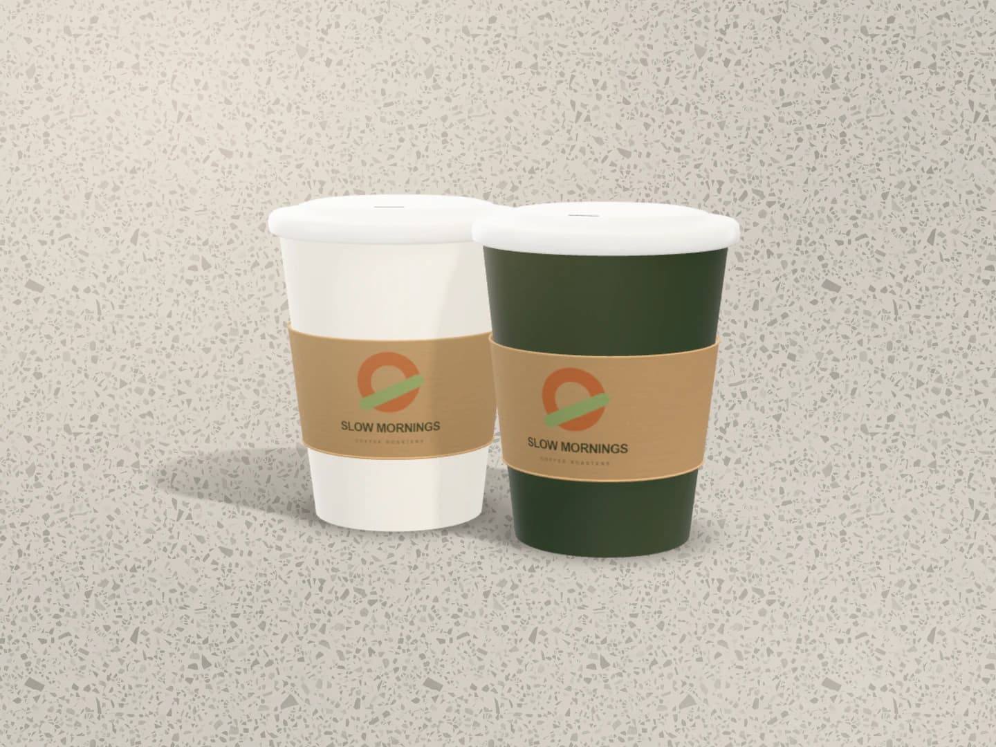 Coffee cup mockup: Two takeaway cups, cream and forest green, on terrazzo
